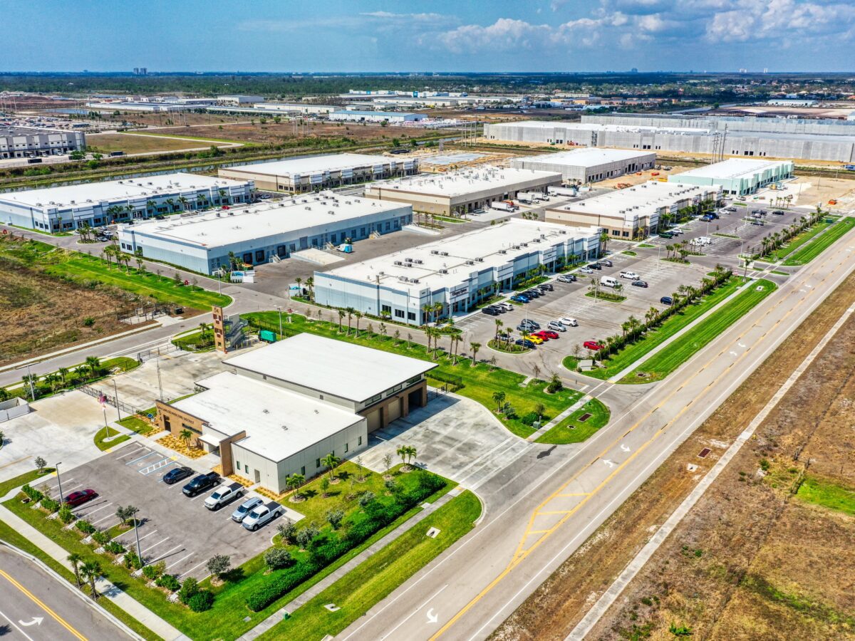 A large warehouse complex with many buildings and lots of parking.