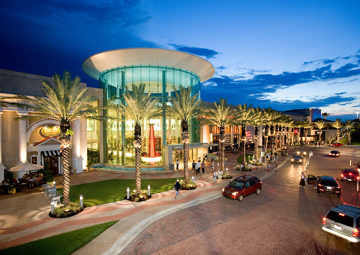 Evening view of modern shopping mall entrance.