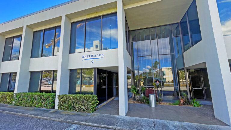 White modern glass-front office building entrance