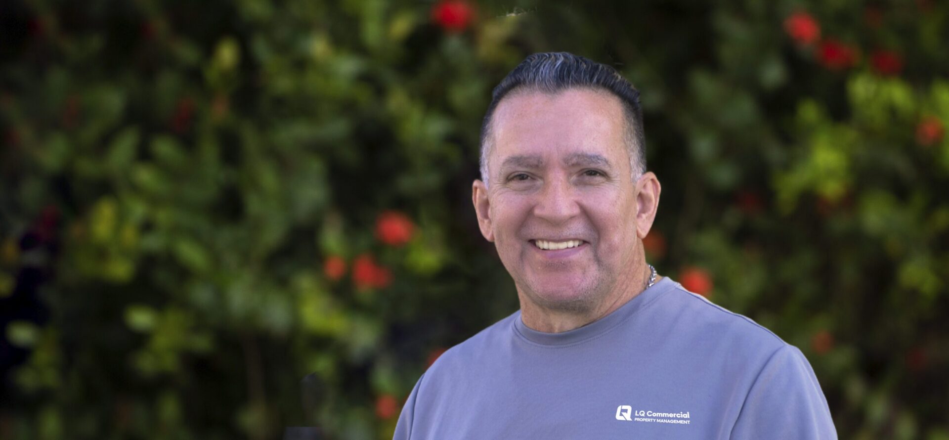 Smiling middle-aged man wearing gray shirt