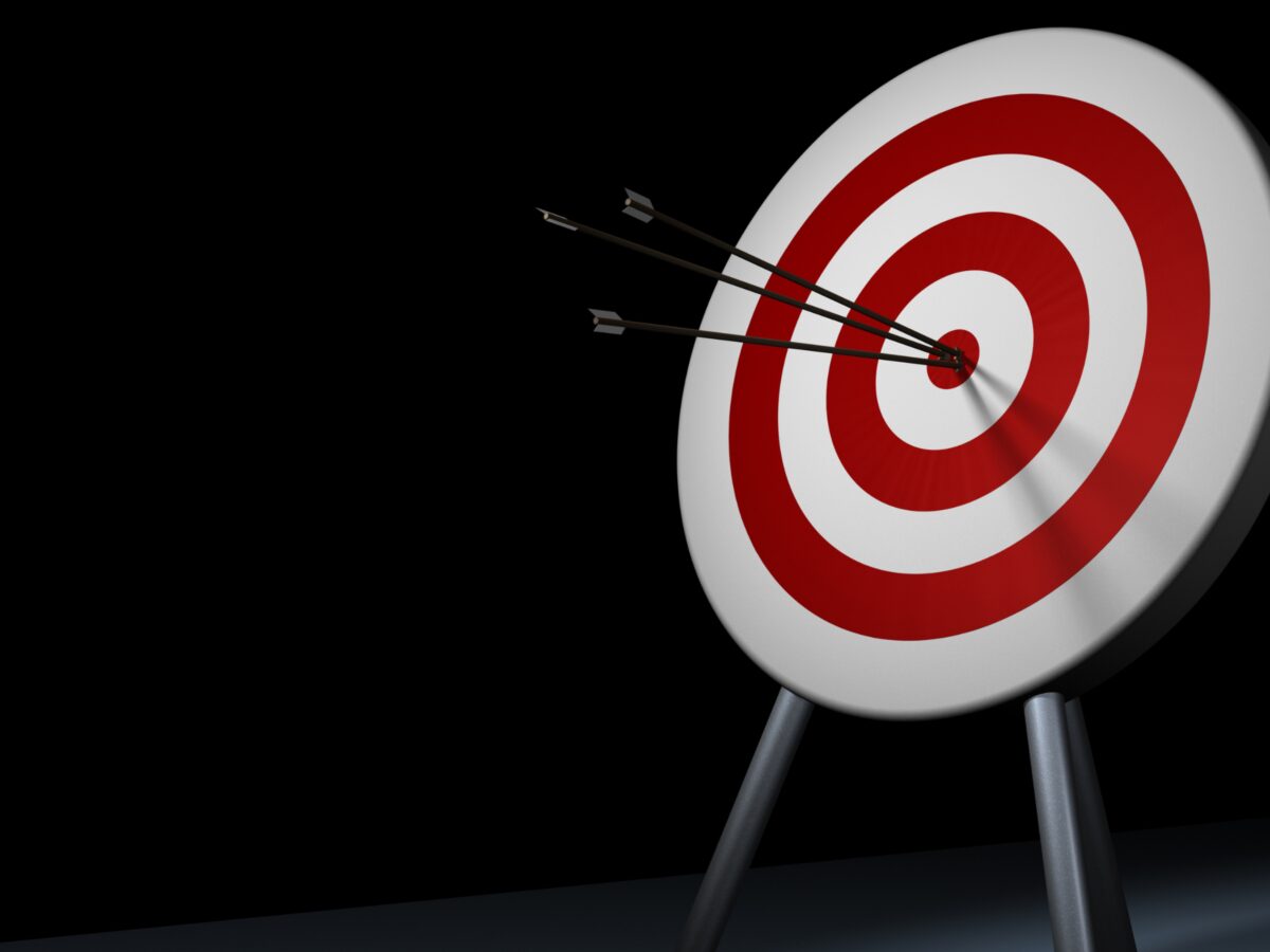 Three arrows hitting bullseye target