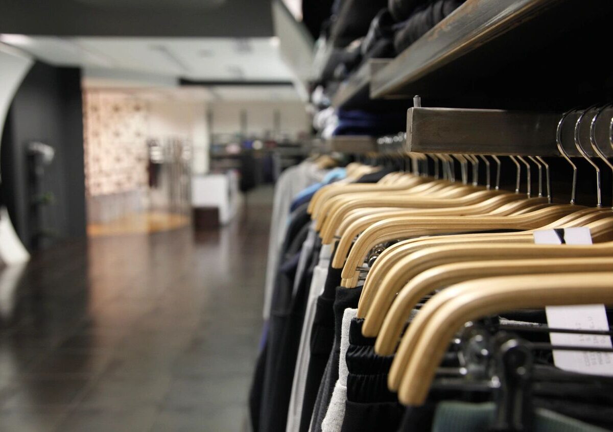 Clothing on wooden hangers in store