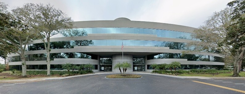 Curved glass office building with circular drive