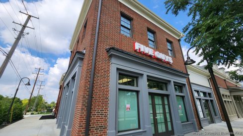 Brick corner Five Guys storefront with red sign